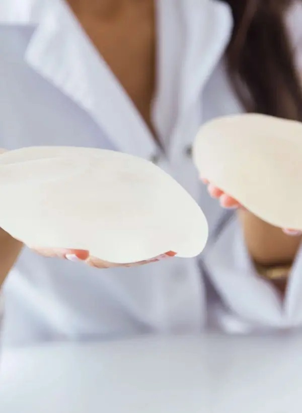 female-doctor-choosing-mammary-prosthesis-office-min