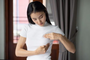 asian woman checking her breast home concept breast cancer awareness month breast cyst tumor inspection body care precautionary preventive medicine